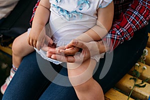 Children`s hands in the hands of an adult.children`s hands in adult hands.adult arms hug childrens. mother holds baby`s hands i