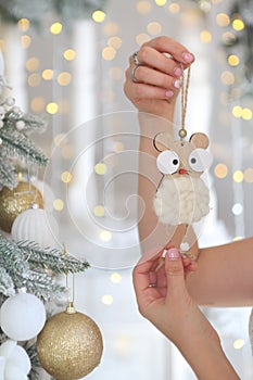 Children`s hands hold a lamb Christmas toy