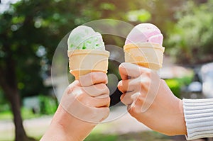 children& x27;s hands holding ice cream cone on summer light nature b