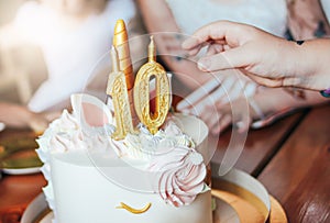 Children& x27;s hands little girls reach for the cake. Big beautiful cake unicorn on the ten years birthday of little Princess on