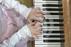 Children's hands on piano keys. children's hands are playing the piano.