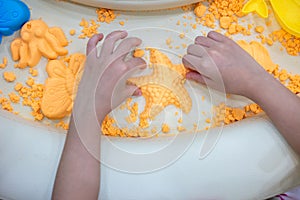 Children`s Hands Playing Kinetic Sand