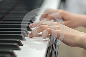 children's hands are playing the piano. Child's hand on piano keys.