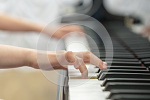 children's hands are playing the piano. Child's hand on piano keys