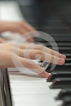 children's hands are playing the piano. Child's hand on piano keys.