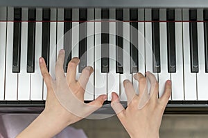 children's hands are playing the piano. Child's hand on piano keys.