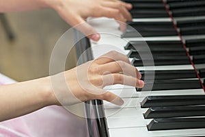 children's hands are playing the piano. Child's hand on piano keys.