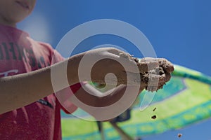 Children`s hands playing in the sand with room to put letters