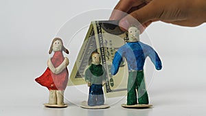 Children`s hands put folded dollar behind the family