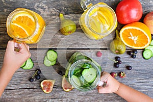 Children`s hands take drinks with fruit