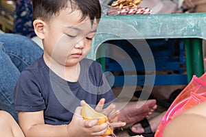 Children `s hands are touching plastic toys in sand on the beach