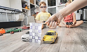 Children`s hobbies: Children play at home with radio-controlled models of cars and organized racing competitions.