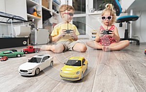 Children`s hobbies: Children play at home with radio-controlled models of cars and organized racing competitions.
