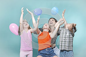 Children`s holiday, mom and children have fun playing with inflatable colorful balls