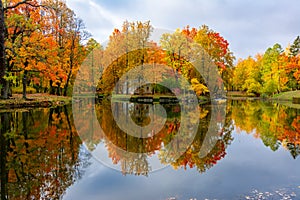 Children`s house in autumn foliage reflected in pond in Alexander park, Tsarskoe Selo Pushkin, St. Petersburg, Russia