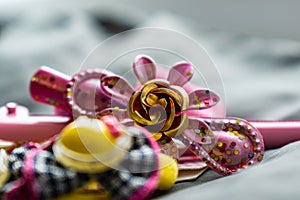 Children`s jewelry set of pink rubber bands and hairpins with pendants in the form of cat faces. Cute and beautiful set for girls