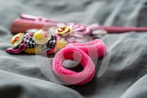 Children`s jewelry set of pink rubber bands and hairpins with pendants in the form of cat faces. Cute and beautiful set for girls