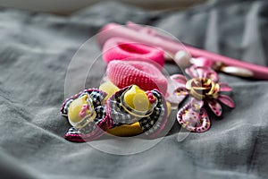 Children`s jewelry set of pink rubber bands and hairpins with pendants in the form of cat faces. Cute and beautiful set for girls