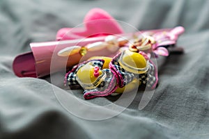 Children`s jewelry set of pink rubber bands and hairpins with pendants in the form of cat faces. Cute and beautiful set for girls