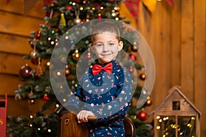 Children`s joyful memories of Christmas holidays. Santa gave a little boy a swing horse