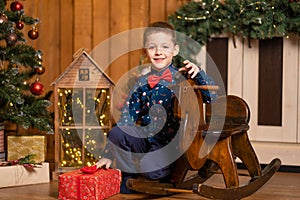 Children`s joyful memories of Christmas holidays. Santa gave a little boy a swing horse