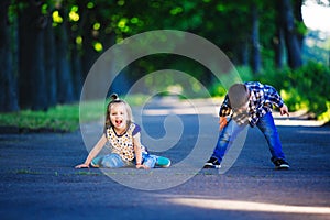 Children`s love, a little boy and a girl, having fun, laugh and smile, and kiss outdoors