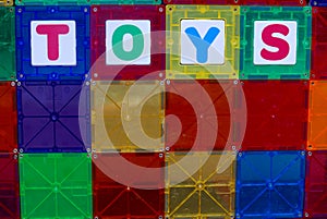 Children`s magnetic building tiles with the word TOYS