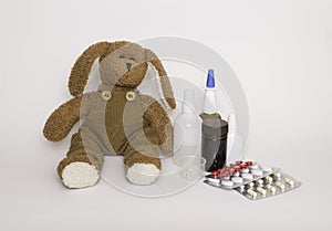 Children`s medicine. Soft children`s toy dog with medicines and tablets next to it. Concept of children`s health and diseases, pro