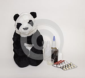 Children`s medicine. Soft children`s toy Panda with medicines and tablets next to it. Concept of children`s health and diseases, p