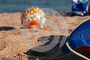 Children`s multi-colored ball on the beach