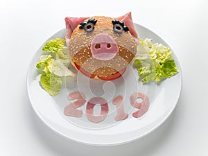 Children`s new year ham burger, lettuce salad and 2019 digits on the plate