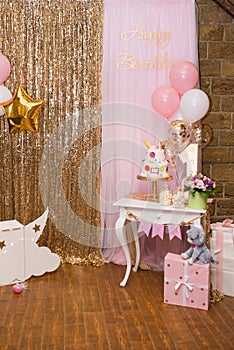 Children`s photo zone with sweets and a balloons. Decorations for a One year old Girlâ€™s Birthday party.