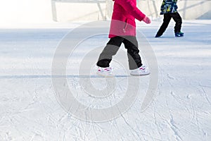 Children`s Plastic Sliding Skates with Size Adjustment close-up on Ice in Winter outdoor. Rolling and sliding in frosty sunny day