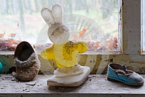 Children`s plastic toy and shoes on windowsill in abandoned kindergarten in destroyed village Kopachi, Chernobyl alienation zone