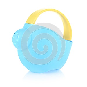 Children's plastic watering can for playing in the sandbox or in the garden. Blue watering can isolated on a white