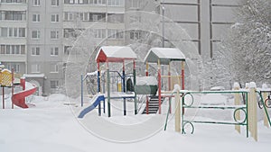 Children`s play complex near house during blizzards