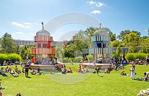 Children's play ground at hot summer day and kids playing with sand and water.