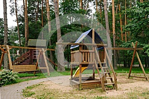 Children`s playground. A children`s slide made of wood and natural materials.