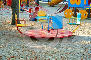 Children`s playground in a city Park early in the morning, various swings and carousels