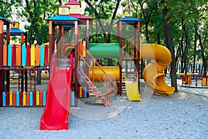 Children`s playground in a city Park early in the morning, various swings and carousels