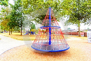 Children`s playground in the city park with a pyramid carousel