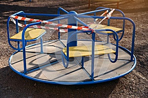 Children`s playground closed and wrapped in alarm caution tape for global coronavirus quarantine.No children on