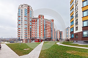 Children\'s playground in the courtyard of a multi-storey residential building against the background of a blue sky