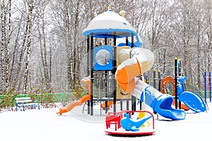 Children`s playground covered with snow