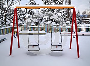 Children`s playground covered with snow