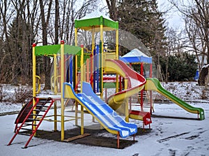 Children`s playground covered with snow