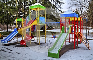 Children`s playground covered with snow