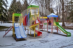 Children`s playground covered with snow
