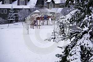 Children`s playground in public park covered in snow