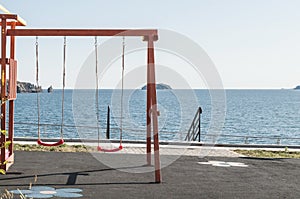 Children`s playground with red swing